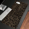 A dark brown leopard print non-slip gaming mouse pad with a white computer mouse resting on it.