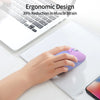 A hand holds a purple gradient cat-shaped wireless mouse on a white tablet beside a laptop.