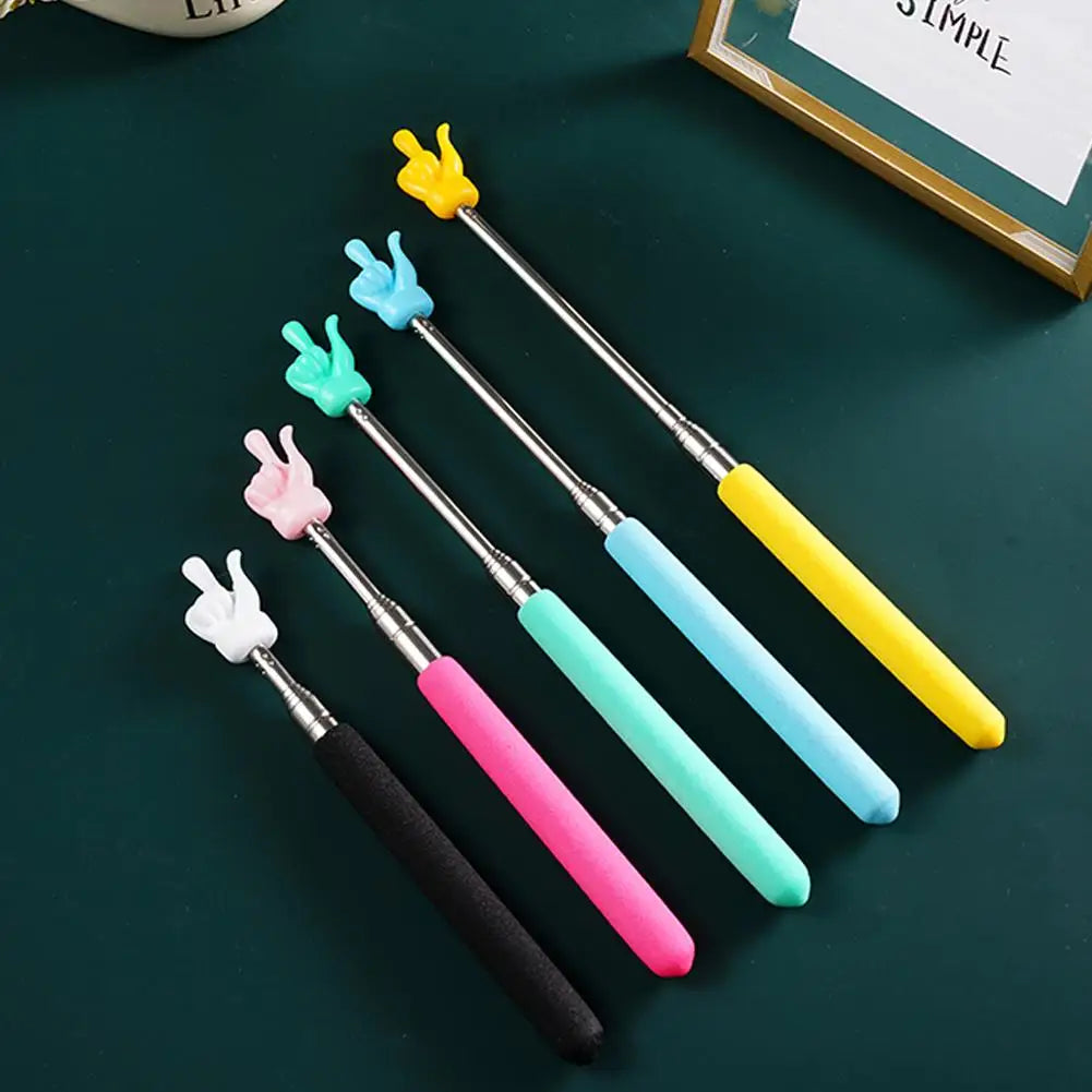 A set of colorful retractable hand pointer sticks with yellow, light blue, pink, and teal tips on a dark green surface.