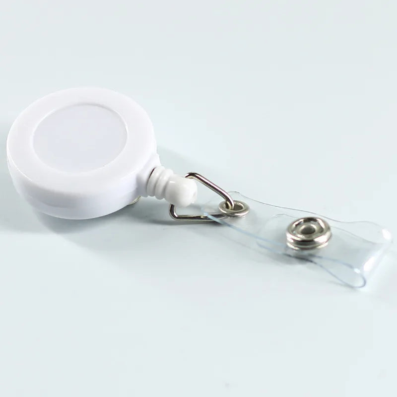 Porta credencial de plástico blanco con correa de plástico transparente y clip metálico.