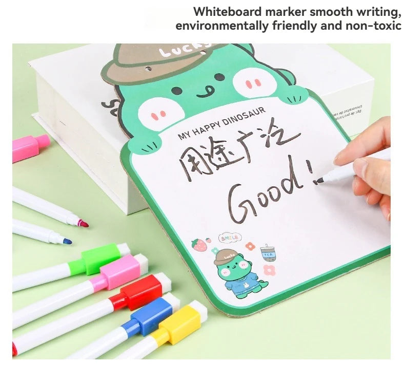 A white board marker is used to write Good! on a board featuring a happy dinosaur design.