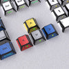 A close-up view of a set of translucent PBT keycaps for a mechanical keyboard, showing various colors and symbols.