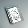 A clear plastic money clip containing a certificate for a 5K monthly savings challenge signed by Cin Girl Cash Stufeer.