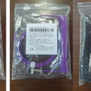 A package containing a purple coiled USB-C cable and various connectors for mechanical keyboards.