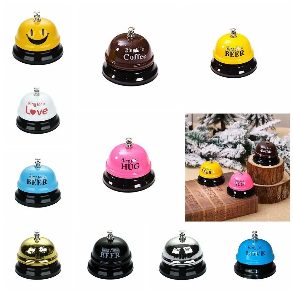 A collection of yellow and black metal service bells shaped like smiling faces, hearts, and bees.