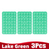 Three light green silicone suction cup phone holders arranged in a row.