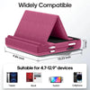 A pink foldable tablet pillow stand with a black case and stylus holders shown in an open angle.