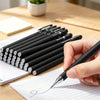 A hand writes on lined paper using a black precision gel pen from a set of writing instruments.