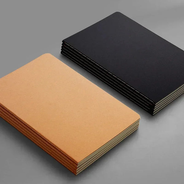 A stack of A5 Kraft cover notebooks in light brown and black on a gray surface.