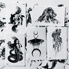 Colección de pegatinas temporales de arte lineal negro con diseños como un león, una sirena y una serpiente.