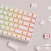 A close-up view of a mechanical keyboard with translucent ice crystal keycaps, showcasing various keycap sets.
