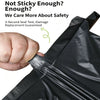 A hand is sealing a black poly mailer bag, demonstrating its self-sealing feature for shipping.