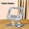 A silver tablet holder with an adjustable foldable design shown on a wooden surface.