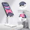 A universal adjustable desk mount holding a smartphone, designed to allow charging while watching media.