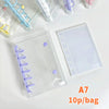 A clear double-button binder for stickers and journaling with purple accents shown on a white surface.