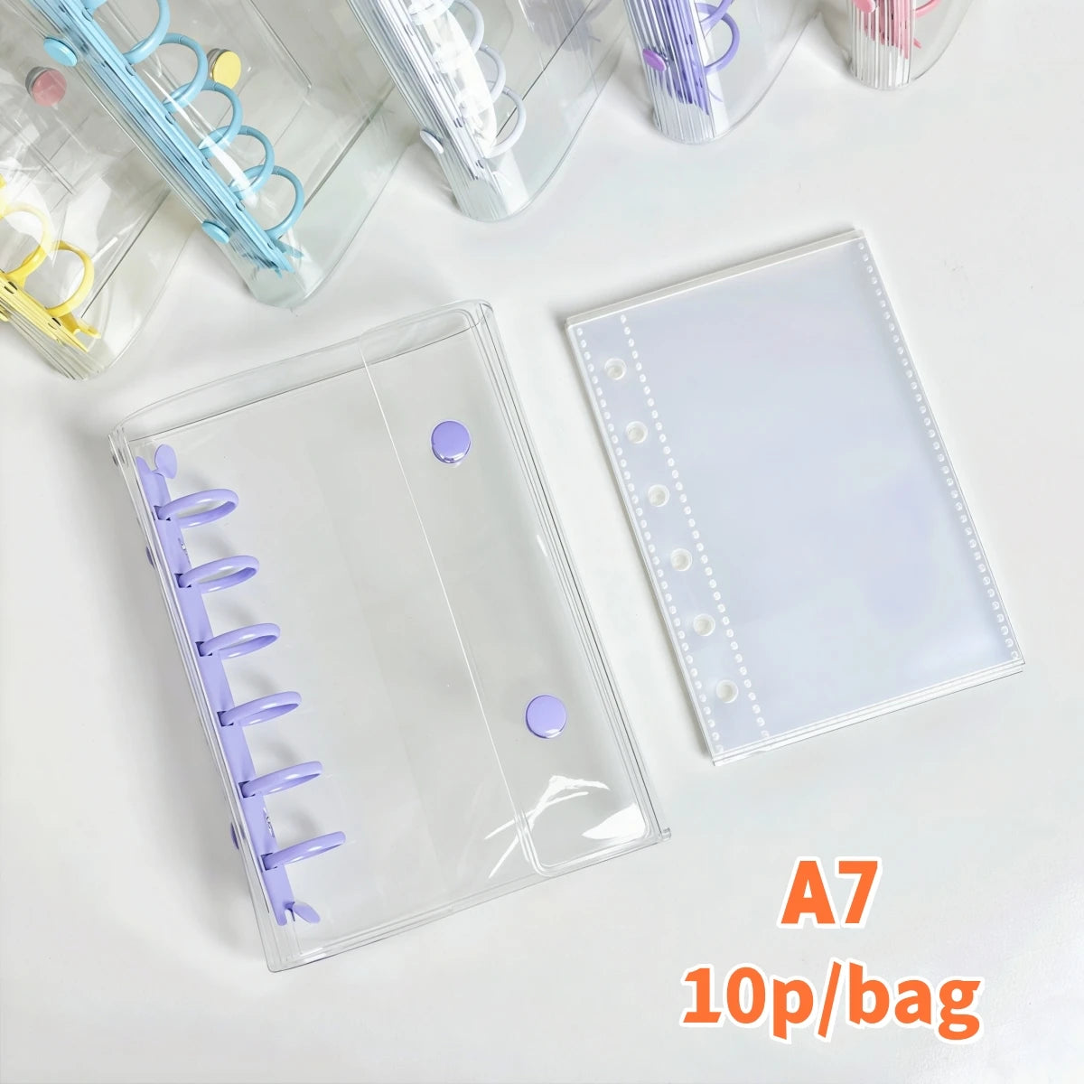 A clear double-button binder for stickers and journaling with purple accents shown on a white surface.