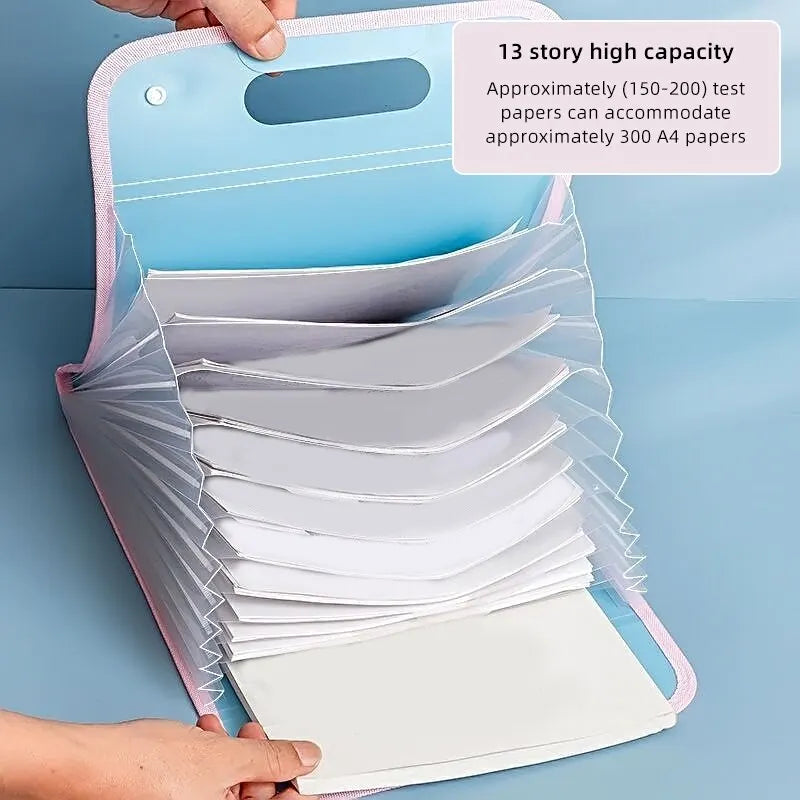 A hand is opening a light blue portable accordion document organizer filled with white papers.
