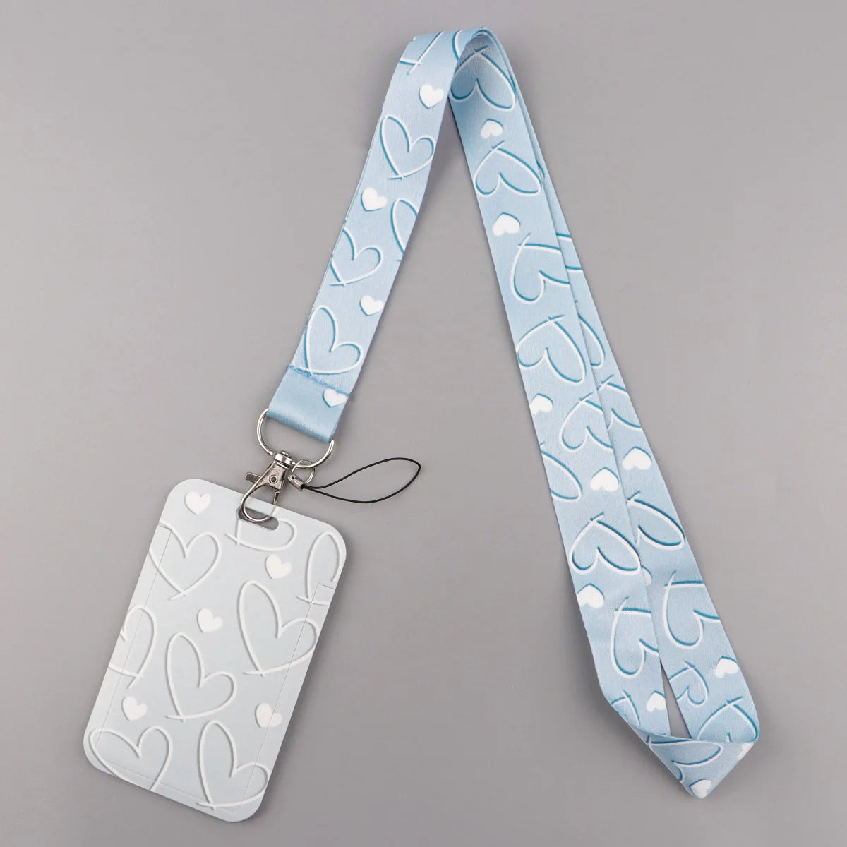 Light blue heart-shaped lanyard with a tag featuring white hearts