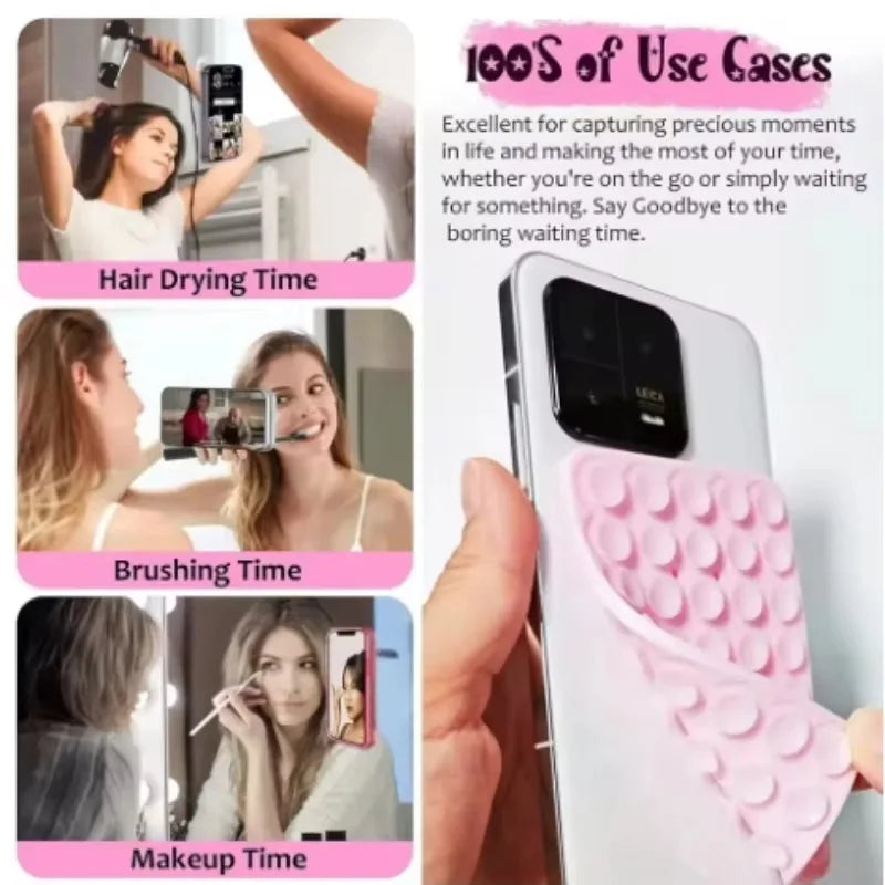A pink double-sided silicone phone mount grip is shown in various use cases like hair drying, brushing, and makeup.