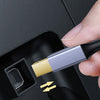 A hand inserts an upgraded USB-C to USB-B printer cable into a printer port.