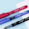 Three signature pens in red, blue, and black are displayed on a light blue background.