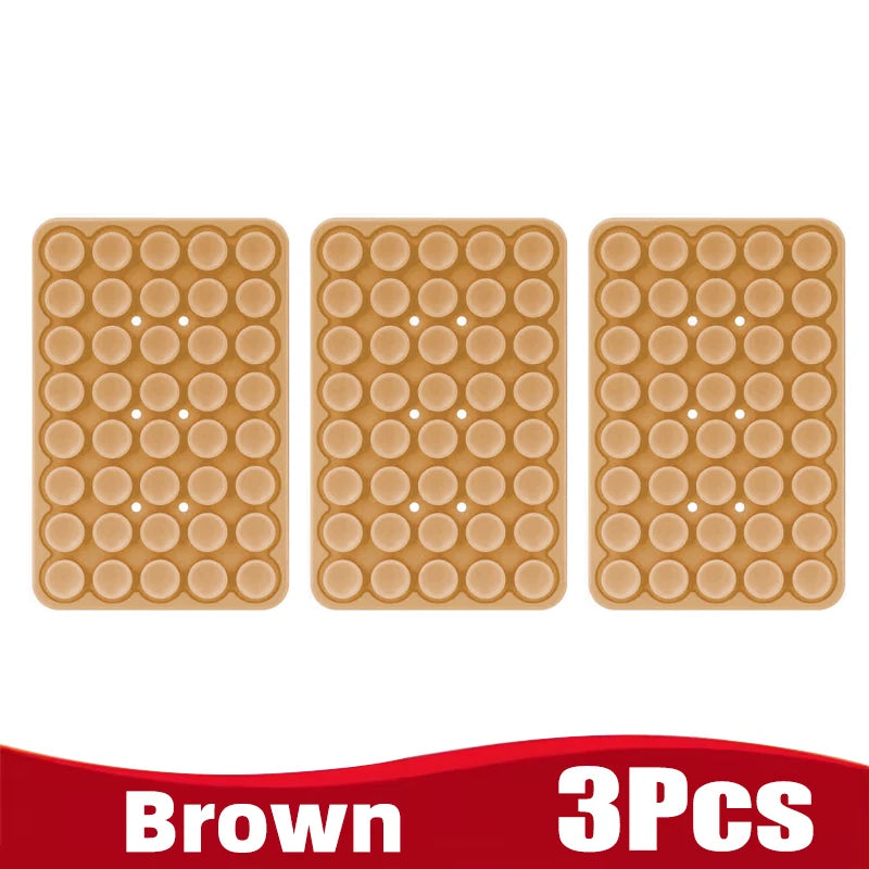 Three brown silicone suction cup phone holders arranged side by side.