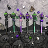 A set of Halloween DIY bead pens featuring witch charms in purple, green, and black.