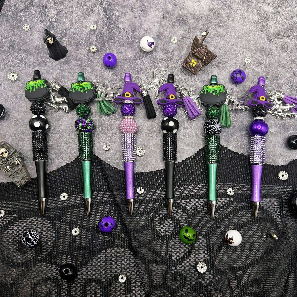 A set of Halloween DIY bead pens featuring witch charms in purple, green, and black.