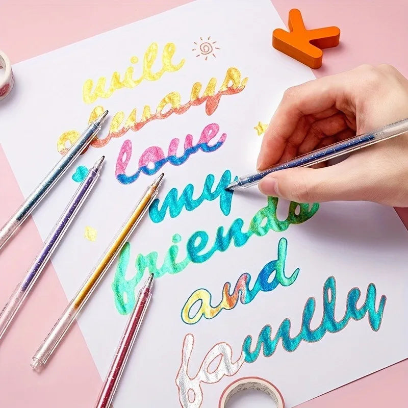 A hand writes 'I will always love my friends and family' on white paper using a set of colorful glitter gel pens.