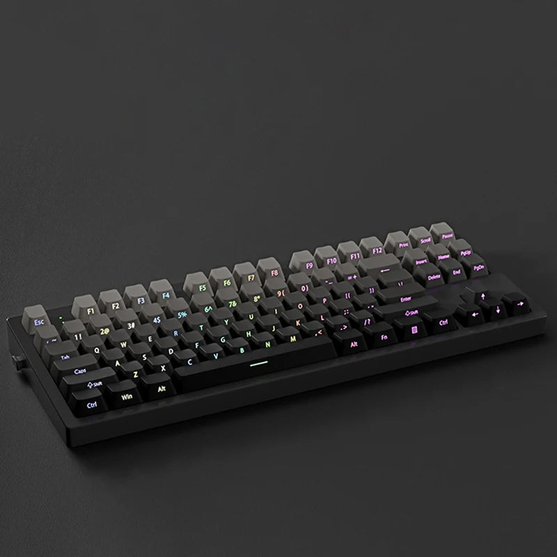 A black mechanical keyboard with gradient gray double shot PBT keycaps and side printing shown from a top-down angle.