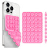 A silver smartphone case with a pink silicone suction cup holder and a matching pink silicone suction cup pad.