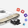 A close-up view of a Universal Type-C to Micro-SD Card Reader device placed next to a smartphone.