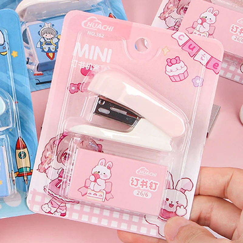 A pink plastic case containing a mini cartoon stapler for students and office use.