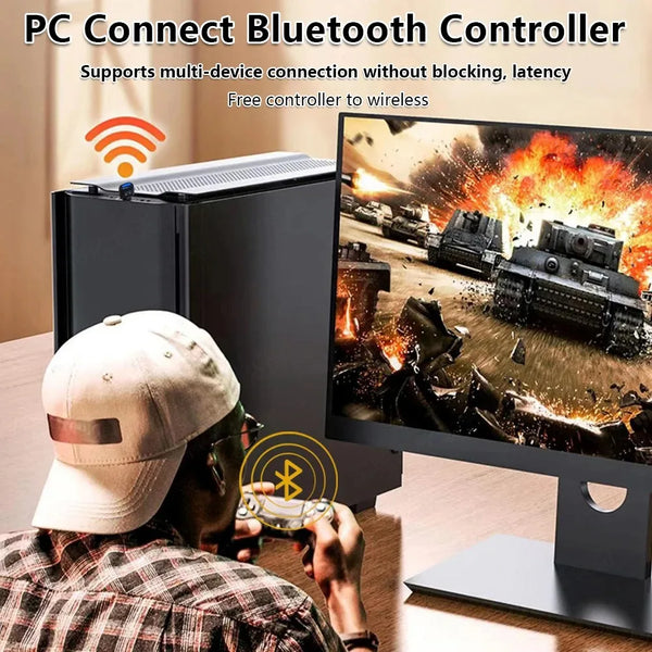 A person wearing a baseball cap is using a PC Connect Bluetooth Controller to control a video game on a monitor.
