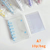 A clear double-button binder for stickers and journaling with colorful plastic accessories.