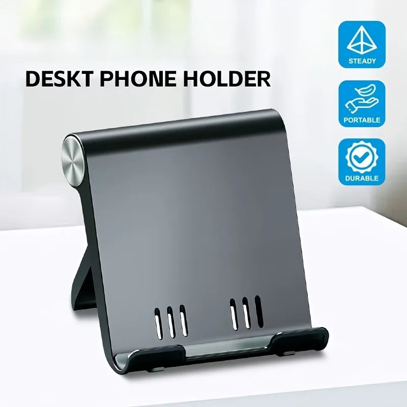 A black foldable desktop phone holder with slots for holding a smartphone.
