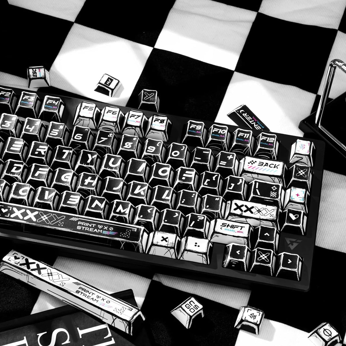 A close-up view of a black mechanical keyboard featuring comic-style PBT keycaps in black and white.