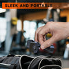 A hand is adjusting a sleek, black magnetic phone holder with an adjustable clamp on a black bag.