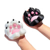 A hand holds a black 3D printed cat paw phone stand with pink accents and an anti-slip base.