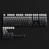 A close-up view of a black mechanical keyboard with gradient gray double shot PBT keycaps and side printing.