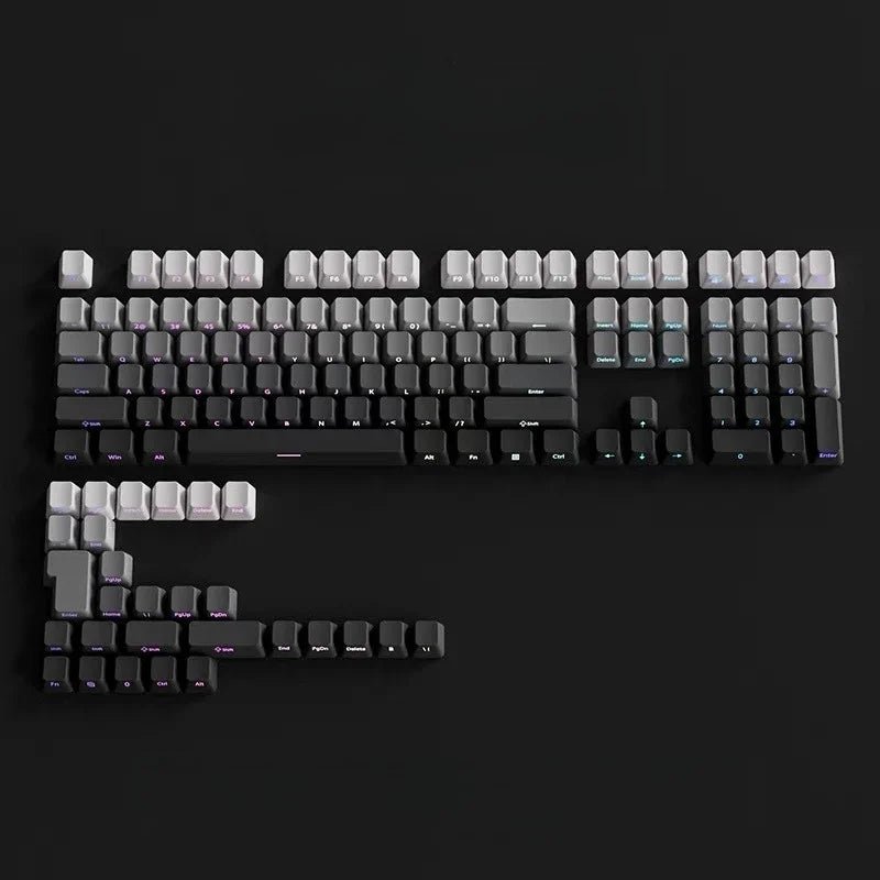A close-up view of a black mechanical keyboard with gradient gray double shot PBT keycaps and side printing.