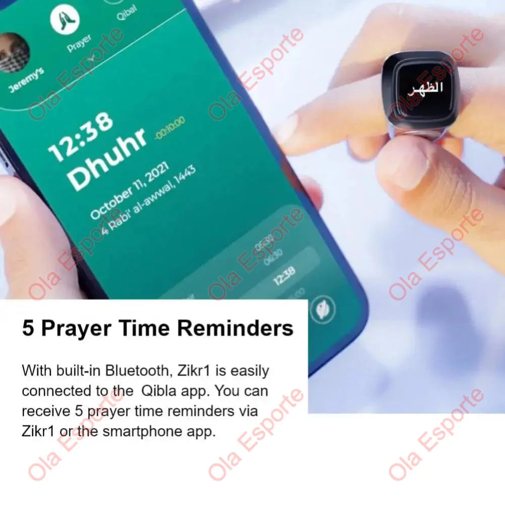 A hand holds a digital Zikr ring displaying the prayer time Dhuhur on a smartphone screen.