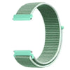 A close-up view of a mint green nylon loop watch strap for kids, showing the textured band and a metal buckle.