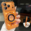 An orange iPhone magnetic stand case with a kickstand is held in a hand, showing the lens protection feature.