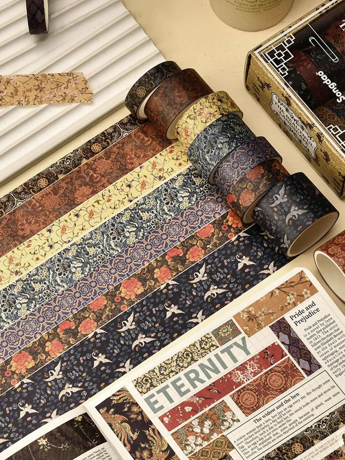 A collection of vintage floral washi tape strips in various patterns and colors displayed next to a box.