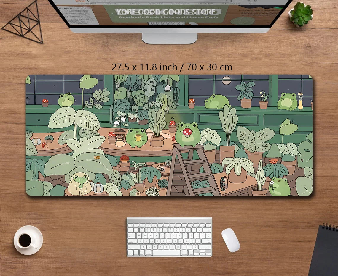 A large desk mat featuring cute green frogs and various potted plants for a gaming setup.