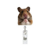 A brown hamster is pictured above a clear acrylic badge reel with a retractable clip.