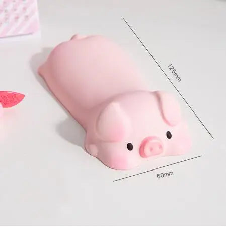 Pink ergonomic wrist rest shaped like a pig for use with a mouse or keyboard.