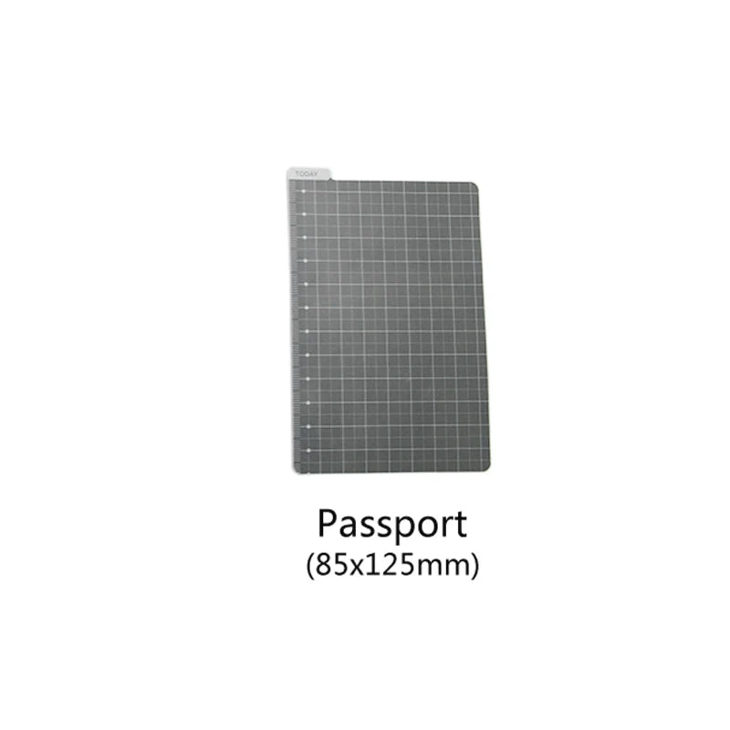 A gray passport-sized notebook shell with a grid pattern.