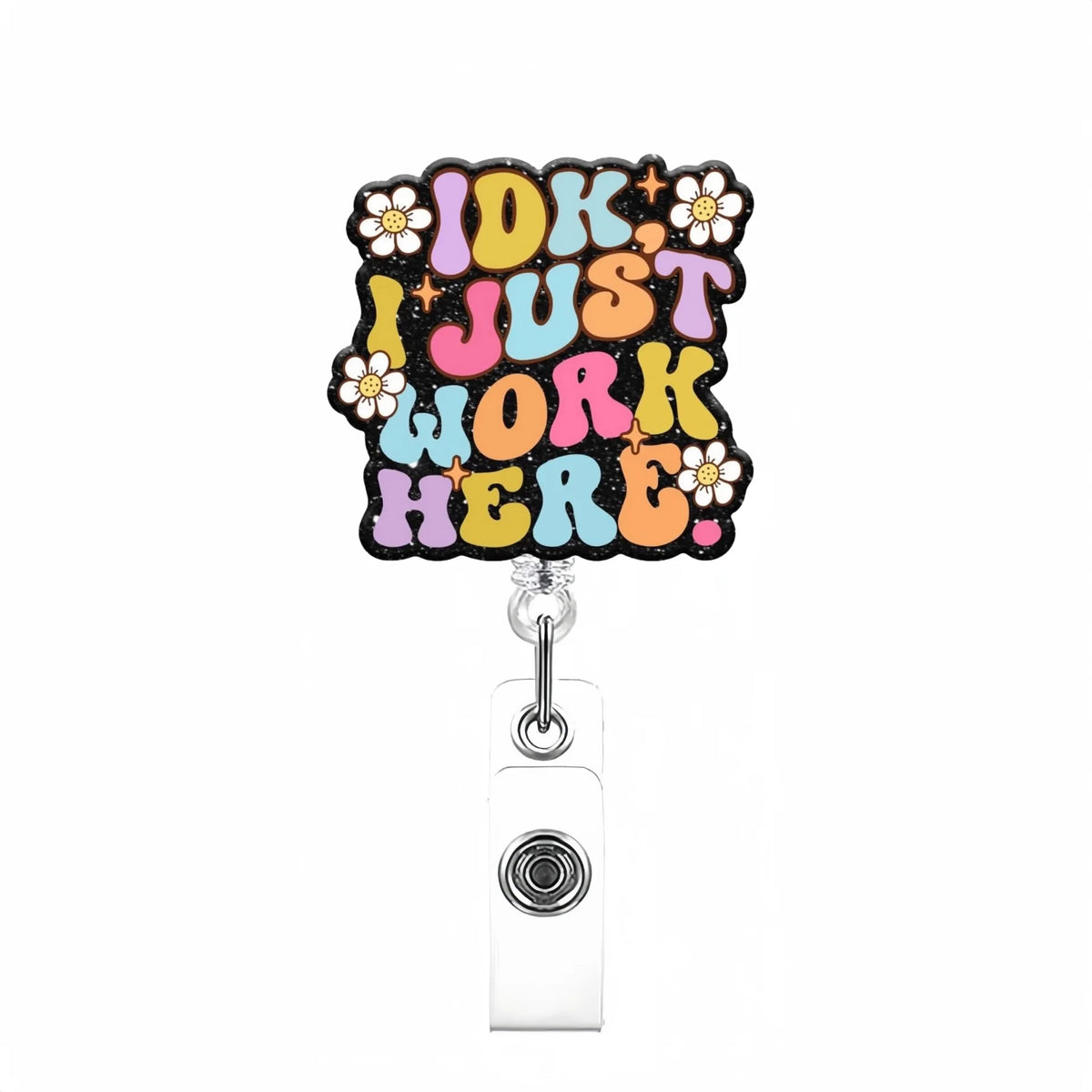 A colorful badge reel featuring the text IDK I JUST WORK HERE in a distressed font with floral accents.